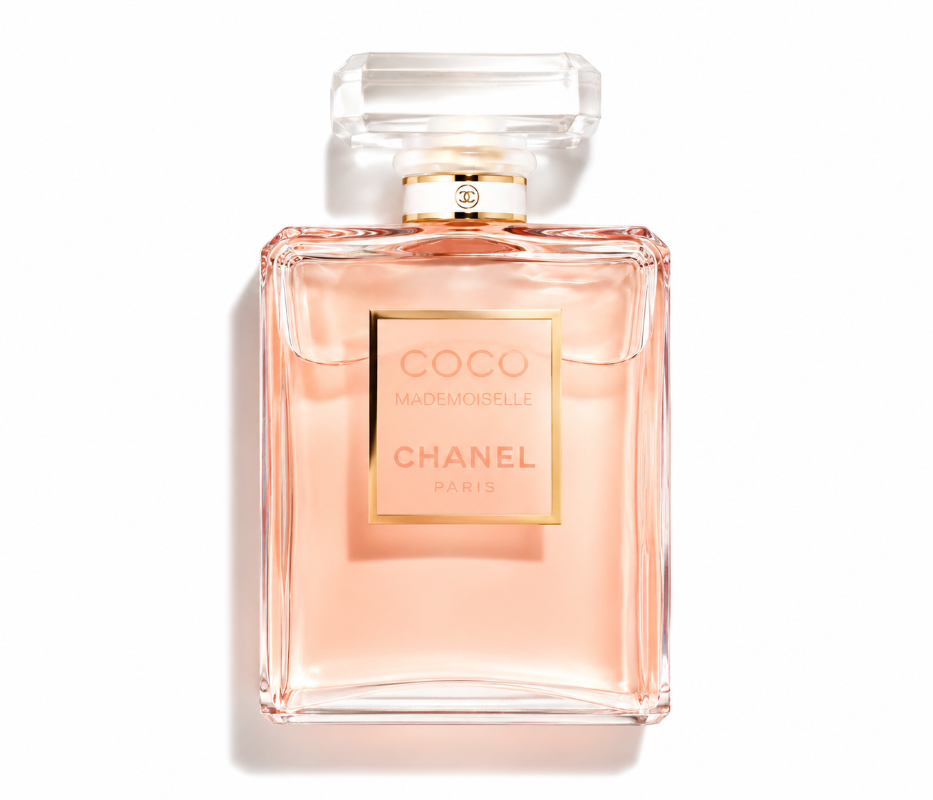 Chanel Coco Mademoiselle perfume bottle in a classic rectangular shape, filled with a pale peach-pink liquid, featuring a gold label and a clear cap, set against a plain white background with a soft shadow.