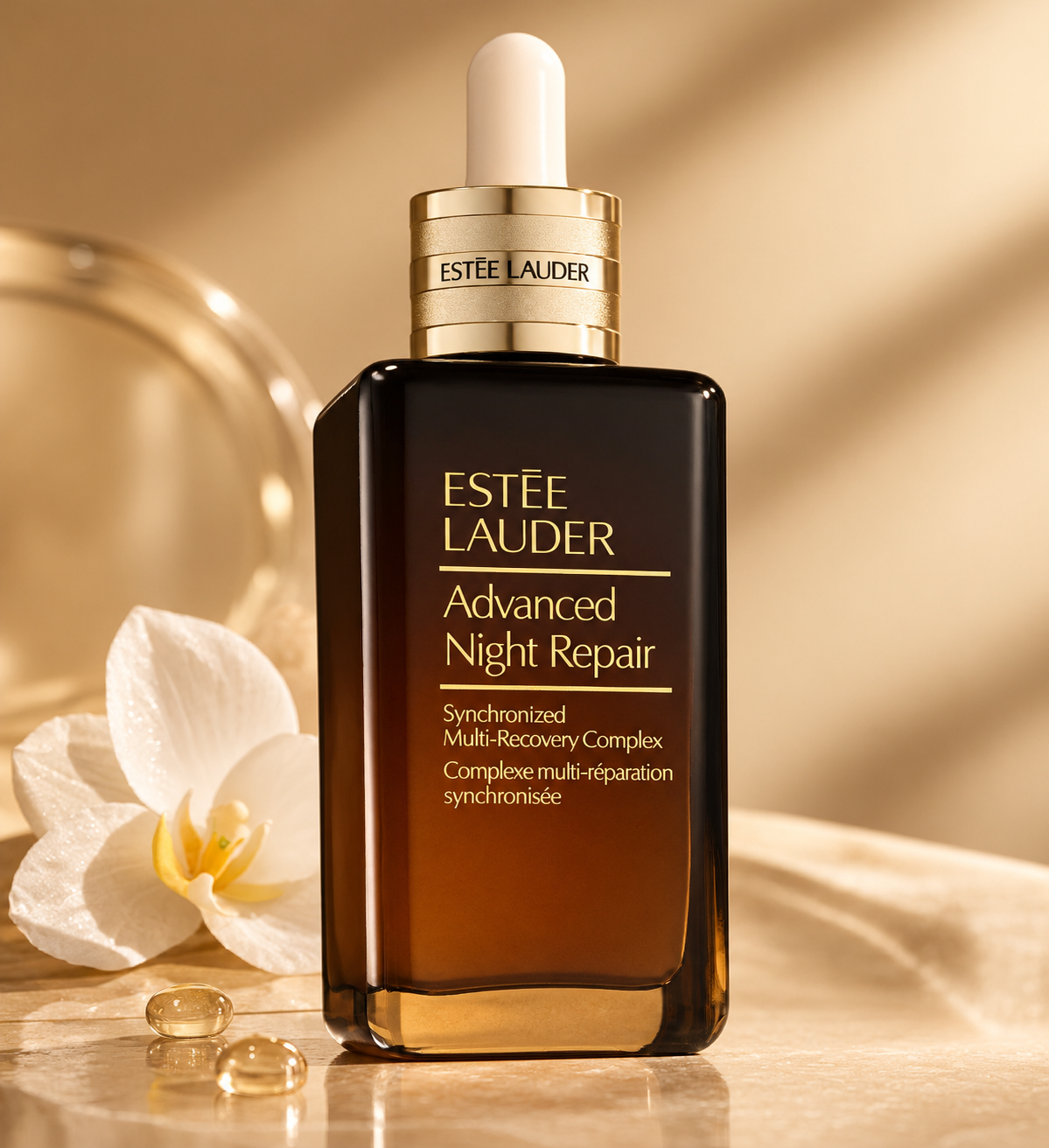 Estée Lauder Advanced Night Repair Synchronized Multi-Recovery Complex anti-aging face serum in an elegant amber glass bottle with a gold dropper, displayed on warm marble beside a delicate white orchid and serum droplets. A luxury hydrating night serum designed to improve skin radiance, smooth fine lines and support skin repair.