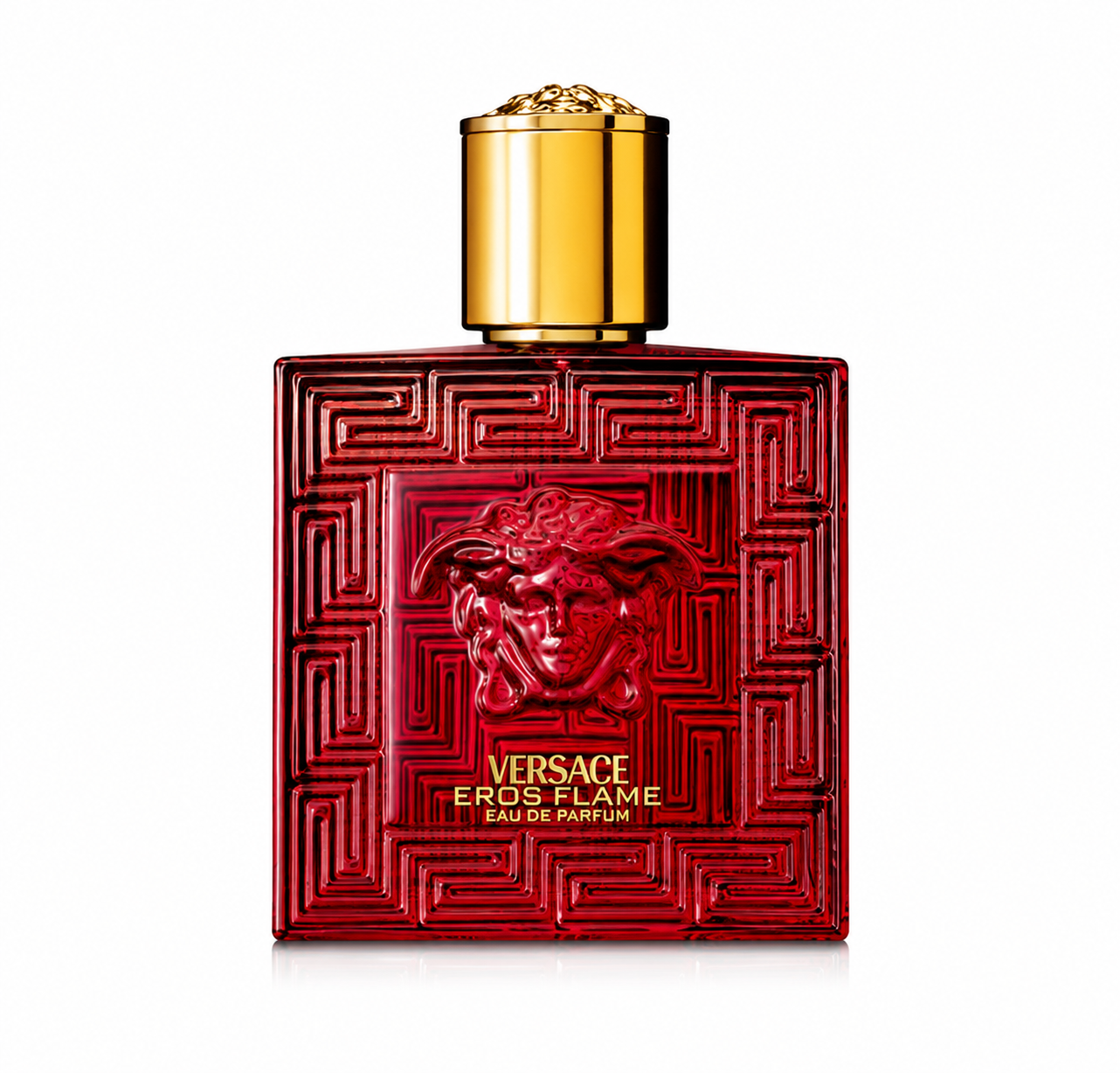 Versace Eros Flame Eau de Parfum bottle isolated on a white background, featuring a striking transparent ruby red glass bottle with the iconic Medusa emblem embossed on the front, intricate Greek key detailing, and a luxurious gold cap, reflecting the fragrance's bold and passionate character.